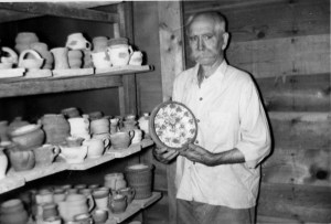 Ebring in his tudio displaying his glazed work prior to firing n.d.