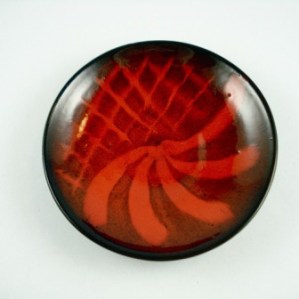 Ernst & Alma Lorenzen plate. Signature. Nova Scotia. Deep oxblood red coloured, with red feathered and latticed design over black interior. Red Clay. 7 ¼” diameter, 1 ½” high