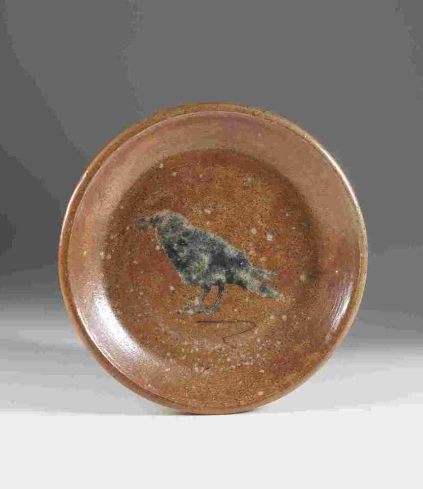 Crow plate, approximately 21 cm in diameter, 2012. Wheel thrown stoneware with stenciled image, wood/soda fired to cone 9-10. Photograph: Barbara Tipton