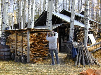John Chalke. Stacking Wood At The Kiln Shed. Photo: Barbara Tipton.