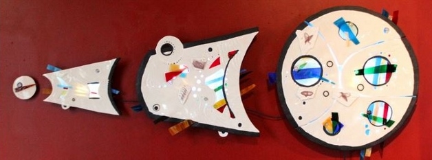 Carol Smeraldo. 2013-14. Expansion. Translucent Porcelain, stained glass, marbles, artist-made decals of whales. Hand built, carved, stretched and cut out. Clear glazed. Cone 6. 2232˚F oxidation. 50.8 h x 127 w cm.