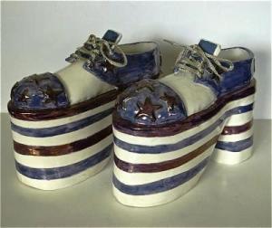 Yonge Street Shoes, 1975, 26 cm long x 17 cm High, porcelain, C/6, Glaze and lustres. Courtesy of the artist.