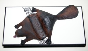 Keith Campbell, Road Kill, 2005 (C/c stoneware) 32 cm x 62 x 15 cm, Handbuilt with sprayed underglaze stains on wood with paint. Courtesy of the artist.