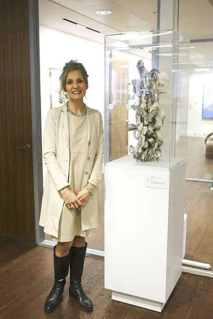 Susan Collett at Canada House next to her work from her Maze Series, Axis ll. approx. 76.2 cm high.