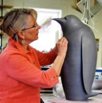 Judy Blake working on a Penguin Sculpture.