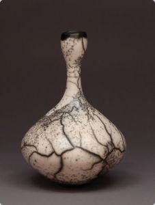 Judy Blake Naked Raku Bottle, 2012. White earthenware in sawdust, 29 cm h x 21.5 cm w.