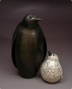 Judy Blake. Smoke-fired Penguins. 2013. Adult sawdust-fired, 58 cm h x 33 cm w, and naked raku Chick, 28 cm h x 20 cm w.