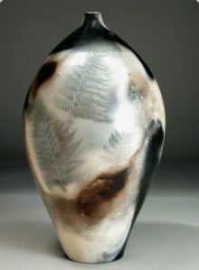 Judy Blake. Smoke-fired Vessel Judy Blake. Sawdust-fired Vessel with 'Fern Shadow, 1999. Porcelain, Sawdust, various kinds and textures, 33 cm h x 18.5 cm w.with 'Fern Shadow. . [clay and combustibles?] 1999. 33 cm h x 18.5 cm w. 