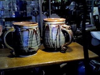 Stan Clarke, n.d. Two mugs. approx. 13.3 cm h x 16.5 cm wide at the handle. John Lawrence Collection.