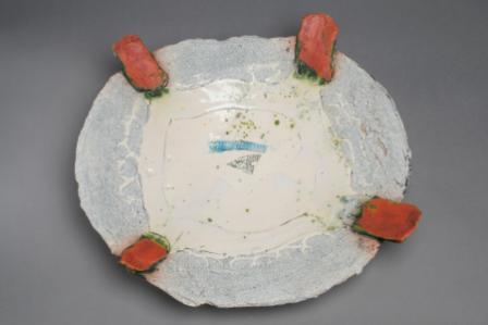 John Chalke. Prelude To A Popular Rest. 2008. 42x44x11 cm. Press-molded plate form with handbuilt additions, multiple glazes and firings, ceramic transfer. Collection of the Alberta Foundation for the Arts.