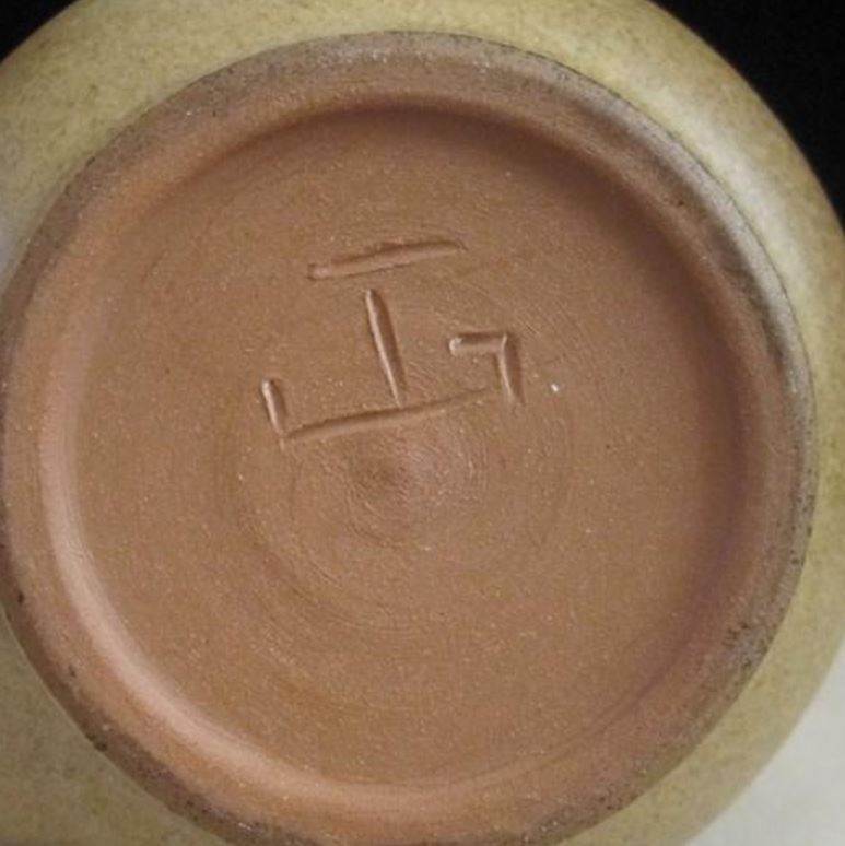 Jan Grove marks on small items such as mugs. Sometimes infilled.