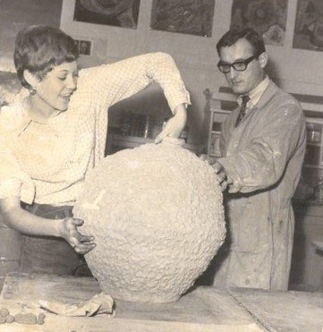Teacher Victor Cicansky looks on as Diana Dobson examines her freshly fired vase." Regina Central Collegiate Fine Arts Program - Clay Saskatchewan Teachers' Federation. Saskatchewan Teachers' Federation fonds, 1.0097.08.[ca. 1968]