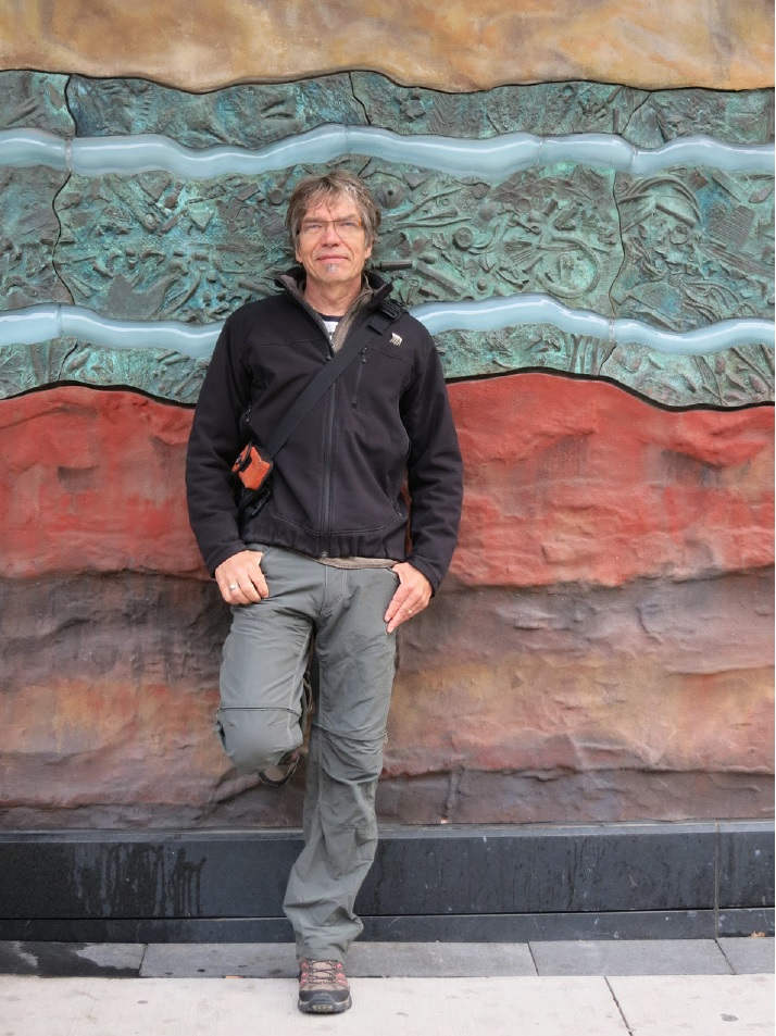 Powning portrait in front of STRATA, Cinema Tower, Widmer Street, Toronto. Precast, pigmented concrete, cast bronze and slumped glass. LED light array.