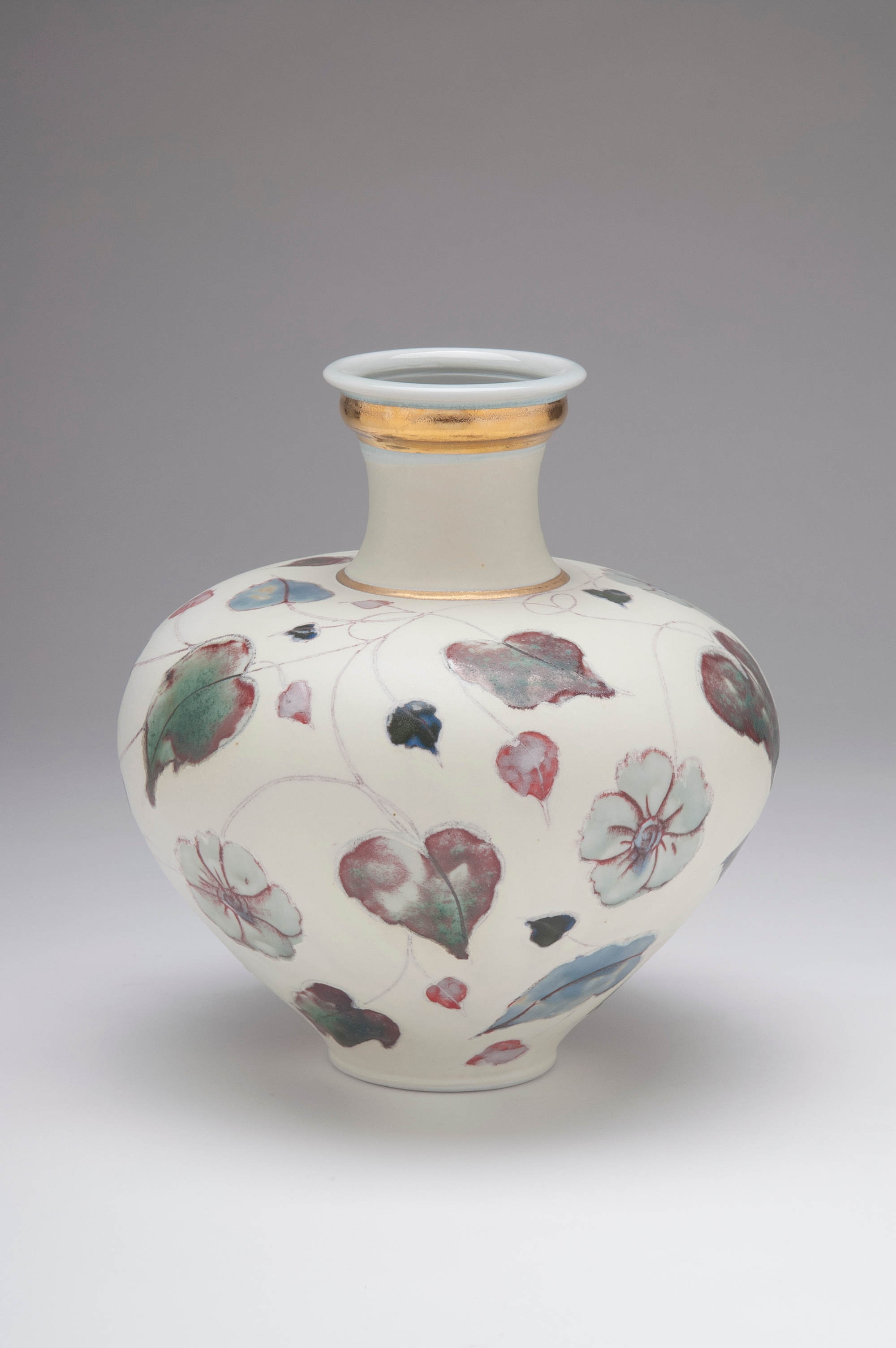 Valerie Metcalfe. 2018. Flowers in the Snow. 33 cm high. Porcelain. Mishima drawing with painted glaze, underglaze and wax design. Gold lustre accents.