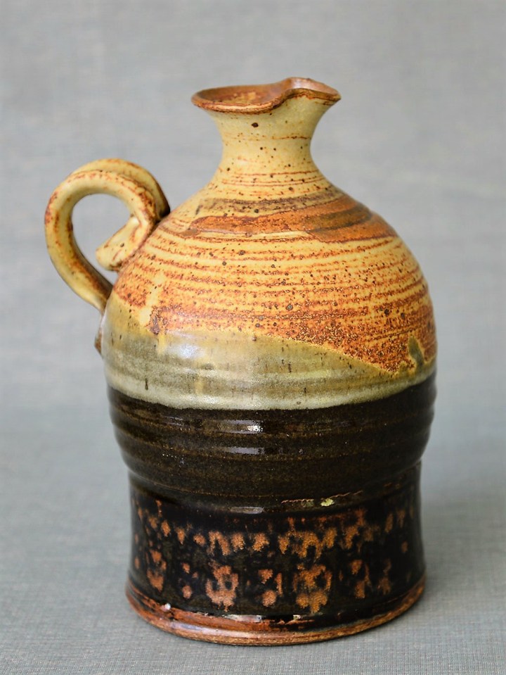 Donn Zver. (1973-83) Jug. 22.0 x 17.0 x 14.4 cm. Thrown stoneware, glaze with stamped design. Collection: Art Gallery of Burlngton.