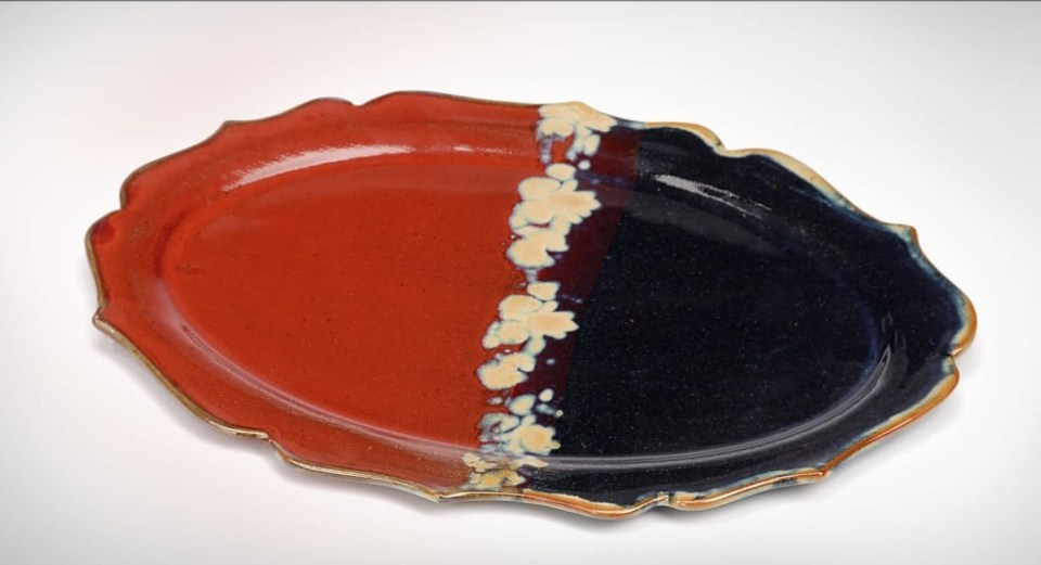 Donn Zver. 2014. Stoneware Tray. Copper red with black with iron and rutile stamp decoration across the surface. 5.1 x 35.6 x 25.4 cm.