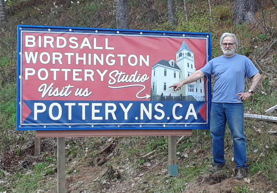 Tim Worthington and the new studio location sign, Mahone Bay