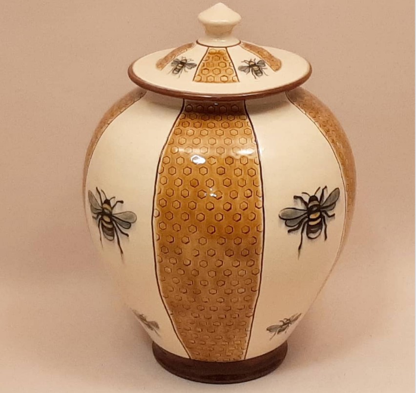 Birdsall Worthngton (Tim Worthington) Pale Yellow Bee Jar. 26.7 cm tall. Lantz clay with white slip and underglaze and stamped decoration. Transparent coloured glaze over the stamped honeycomb. Cone 03.