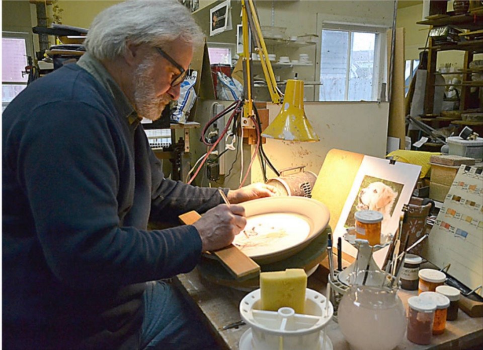 Tim Worthington slip decorating a commemmorative plate. Photo: Gayle Wilson