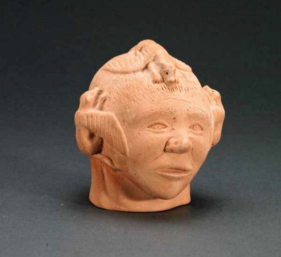 Robert Tatty (1927-), E3-404, Rankin Inlet. A Head With Flying Dogs, ceramic, signed in syllabics with disc number, 19.1 x 17.8 x 15.2 cm. Photo: katilvik.com.