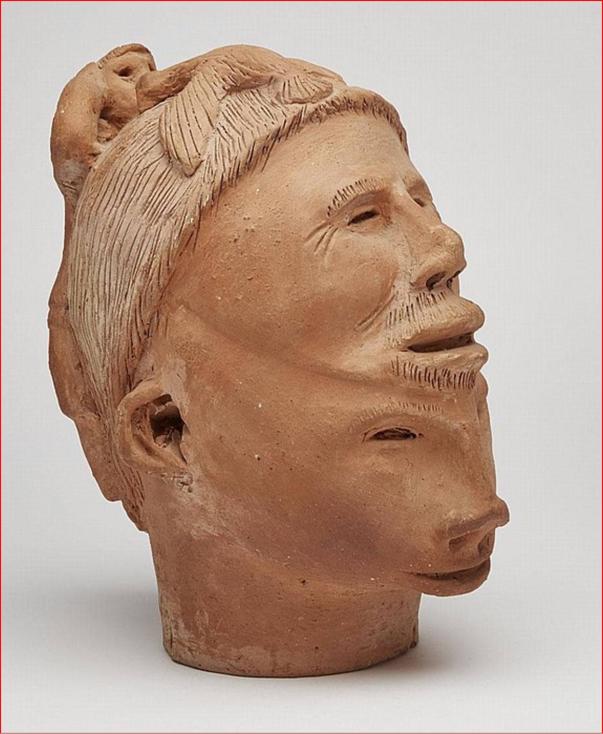 Pie Kukshout (1896 - 1980) Two Faced Head with Climbing Figure and Bird. Ceramic. 27.9 x 17.8 x 22.9 cm. Invaluable.