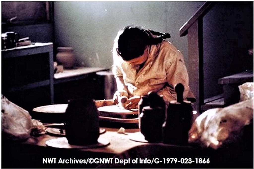 Woman works with clay on potter's wheel, Rankin Inlet Potttery studio, ca.1971. Copyright held by the Government of the Northwest Territories. NWT Archives, Northwest Territories. Department .